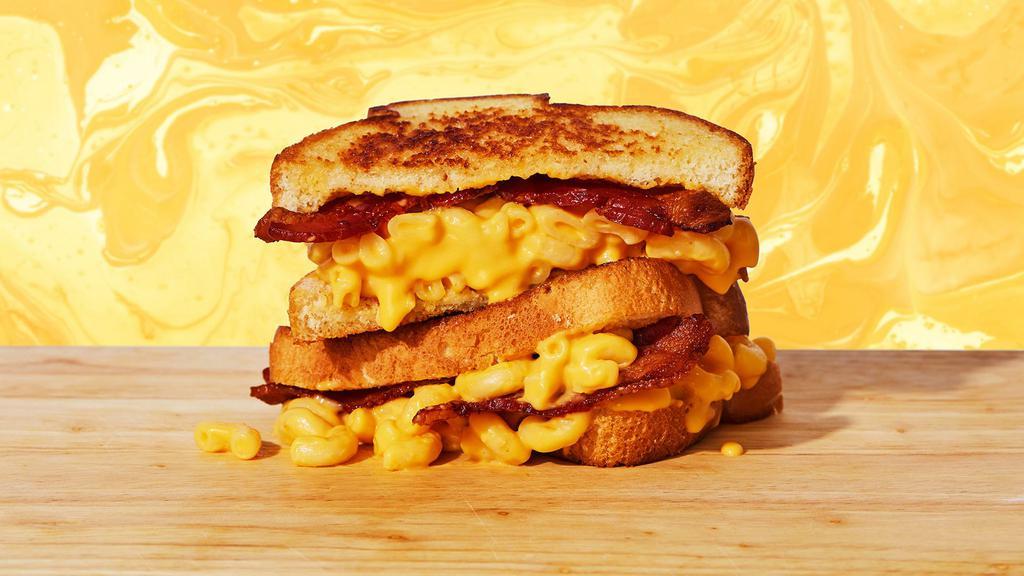 Mac Attack Grilled Cheese · Creamy classic mac and cheese with crispy bacon on two slices of buttery grilled bread.