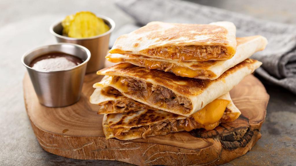Carne Asada Quesadilla · Sautéed skirt steak with caramelized onions, roasted red peppers, melted cheddar cheese, and chopped jalapeños on a crispy tortilla.