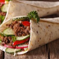Taco Burrito · Burrito stuffed with ground beef, cheese, tomatoes, lettuce, and homemade hot sauce.