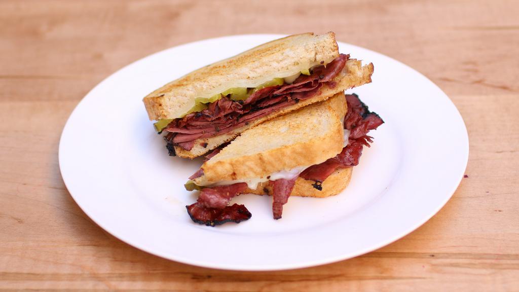 Pastrami · Gourmet pastrami, provolone cheese, pickles, & mustard , mayo served on sourdough.