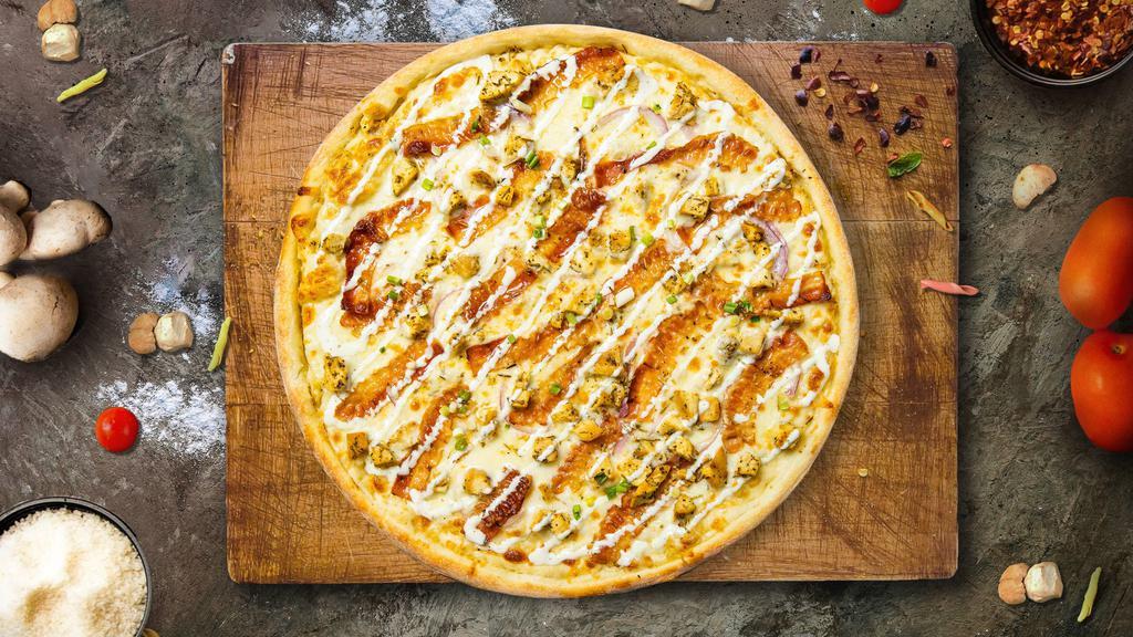 Garlic Chicken Pizza  · Creamy garlic sauce, healthy portion of chicken, red onions, mozzarella cheese, cheddar cheese, fresh garlic, and green onions.