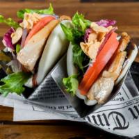 Pork Buns. · House made pork chashu, lettuce, tomatoes, red onions and garlic chips with eel mustard sauce