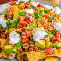 Nachos Supreme · Warm and crispy tortilla chips topped with melted cheese, hearty beans, and house made pico ...