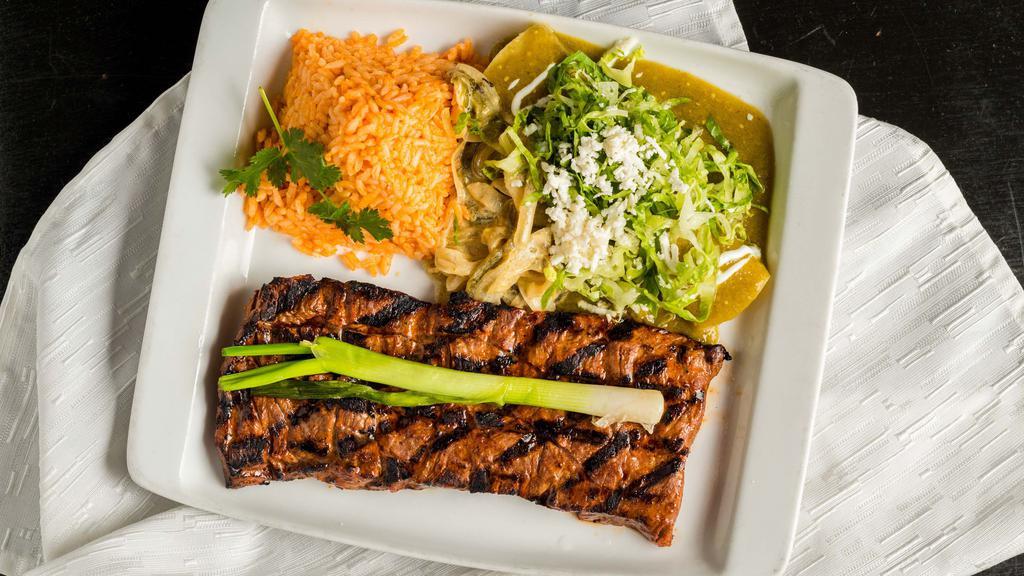 Arrachera Méxicana Con Enchilada · Marinated flank steak paired with a chicken enchilada in a green tomatillo salasa, side of rajas de chile poblano and is served with rice.