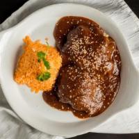 Mole Poblano Con Pollo · Signature dishes from Puebla. Mole made with 32 ingredients. Served with braised chicken and...