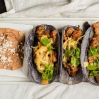 Tacos Poblanos De Arrachera · Three large tacos on blue corn tortillas filled with marinated flank steak, roasted poblano ...