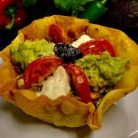 Super Taco Salad · Shell flour tortilla. Meat, beans, lettuce, tomato, cheddar cheese, guacamole, sour cream, t...