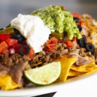 Super Nachos · Your choice of meat, chips, beans, cheese, tomatoes, jalapeños, sour cream, guacamole and ol...