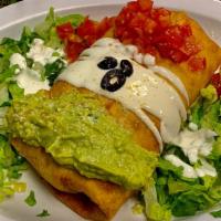 Chimichangas · Your choice of meat, beans, potatoes, eggs, and cheese. Topped with guacamole, sour cream, l...