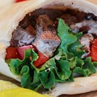 Tri - Tip Shawarma Wrap With French Fries And Drink · Marinated and sliced beef, wrapped with tahini, onions, tomatoes, lettuce and pickles.