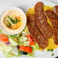 #11. Gyros · Seasoned sliced beef served with hummus, salad, rice, onions, tzatziki sauce and pita bread.