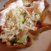 Taco Salad · Hard shell bowl with beans, lettuce, tomato, sour cream, cheese and your choice of beef, chi...