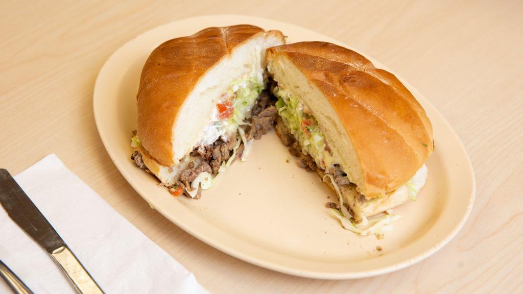 Torta · Grilled Mexican sandwich spread with mayonnaise, filled with beans, your choice of meat, lettuce, tomato, onion, cilantro, cheese and salsa.