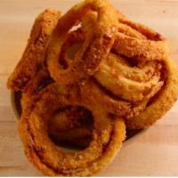 Onion Rings · Our hand-dipped breaded onion rings, fried to a crisp golden brown. Served with ranch dressi...