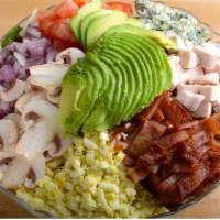 Classic Cobb Salad · Crisp greens topped with a colorful blend of chopped bacon, blue cheese crumbles, hard-boile...