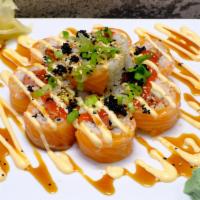 Orange Blossom · Spicy tuna, avocado, cucumber, topped with salmon, tobiko, chives, spicy mayo, sriracha, and...