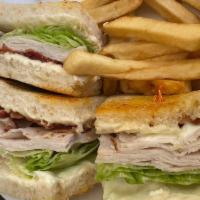 Turkey Bacon Club · White breast of turkey, Danish ham, lettuce, tomato, Swiss cheese, and mayo on grilled sourd...