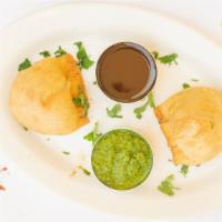 Samosa · Crispy puffs filled with minced potatoes and green peas.