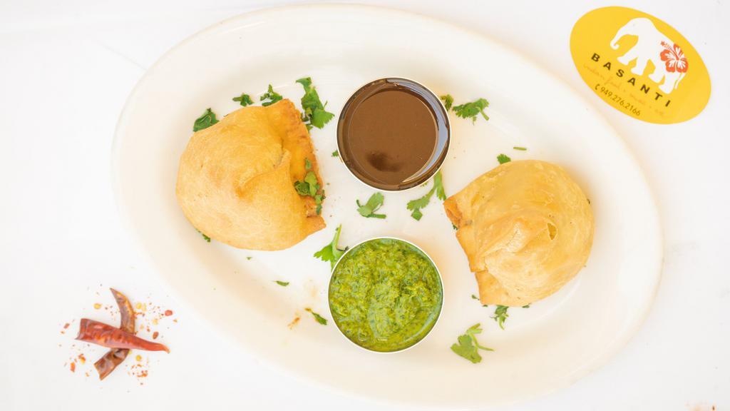 Samosa · Crispy puffs filled with minced potatoes and green peas.