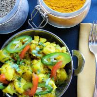 Aloo Gobhi · Potato and cauliflower tomato, onions and curry spices.