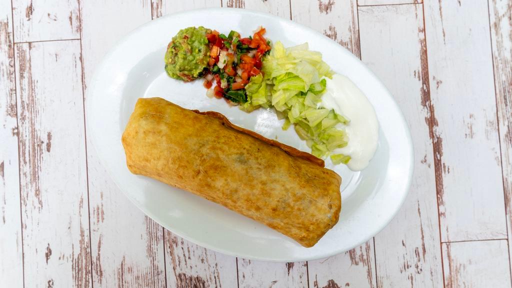 Chimichanga · Meat, rice, beans, and cheese. On the side sour ceam, guacamole, pico de gallo and lettuce.