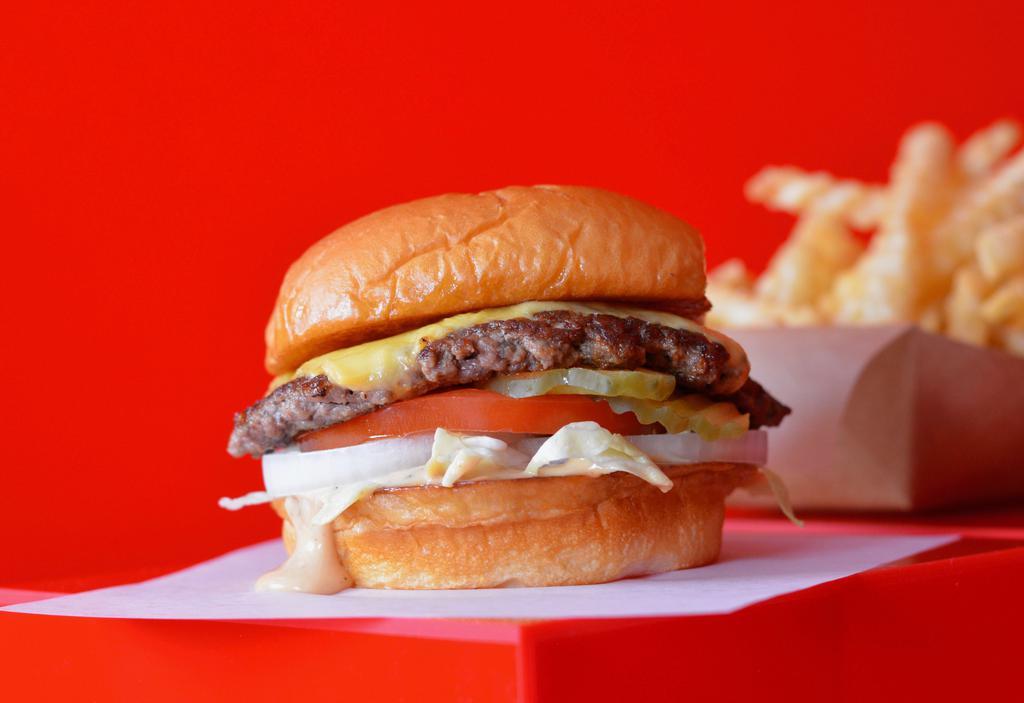 Super Smash Cheeseburger Combo · Juicy, grilled beef burger smashed to perfection with American cheese, fresh shredded lettuce, sliced tomato, onion, pickles and Smash Sauce on a toasted potato bun + Fries