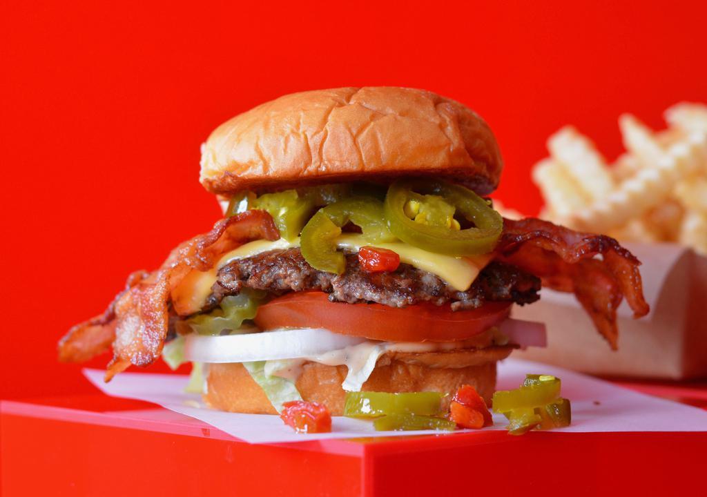 Super Smash Jalapeno Bacon Cheeseburger Combo · Juicy, grilled beef burger smashed to perfection with pepper jack cheese, smoked bacon, jalapenos, fresh shredded lettuce, sliced tomato, onion, pickles and Smash Sauce on a toasted potato bun + Fries