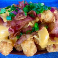 Loaded Tots · Tater tots loaded with nacho cheese, bacon, and green onion.