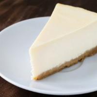 New York Style Cheesecake · A slice of our perfectly made, rich dessert cake made of cream cheese atop a graham cracker ...