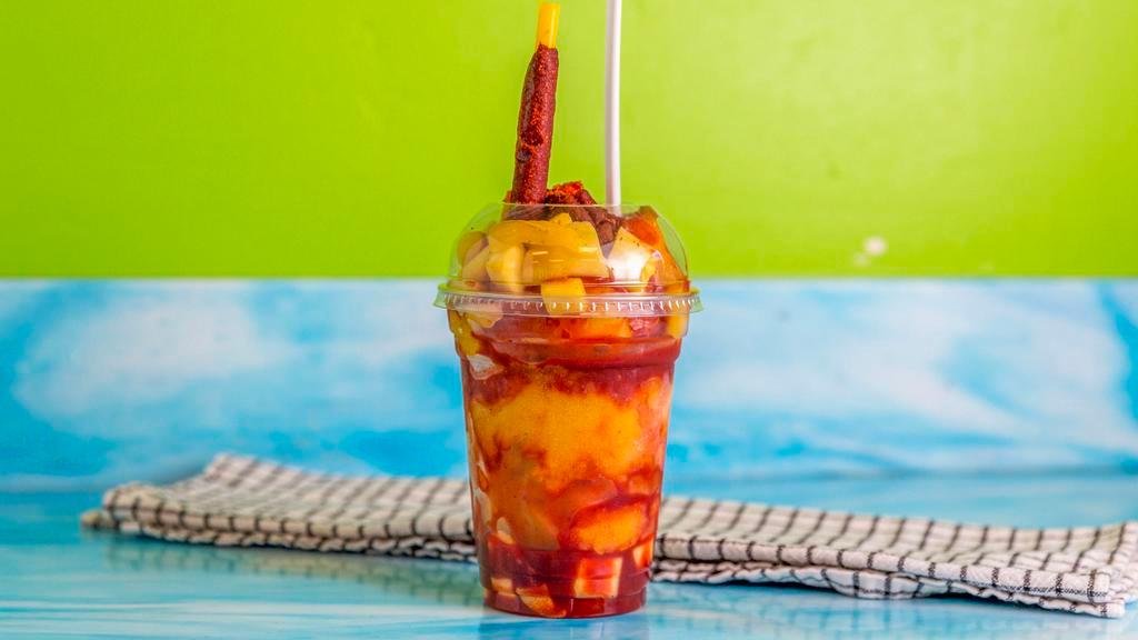 Mangonada · Ingredients (mango, chamoy, tajin, mango freeze, tamarind candies, and a tamarind javelin).