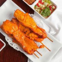 Chicken Satay (4) · Strips of grilled chicken breasts marinated with spices on wood skewer served with peanut sa...