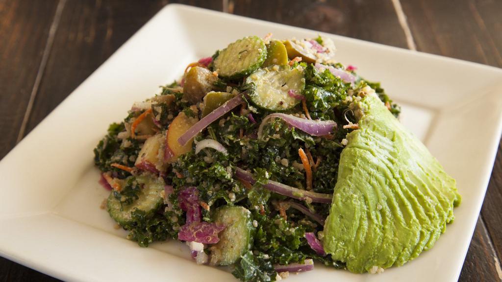Goatless Greek Salad · Gluten-free. Soy-free. A chopped, tossed salad with massaged kale, quinoa, carrots, cucumbers, spicy pickled cabbage, tomatoes, onion, avocado, apple, kalamata olives, raw hot sauce, cashew dill ‘cheese’, and cashew alfredo.