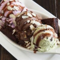 Brownie Sundae · Baked gluten-free brownie with a scoops of chocolate, strawberry and vanilla ice cream toppe...