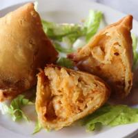 Vegetable Samosa (2 Pieces) · Lightly spiced Indian turnovers, stuffed potatoes and peas.