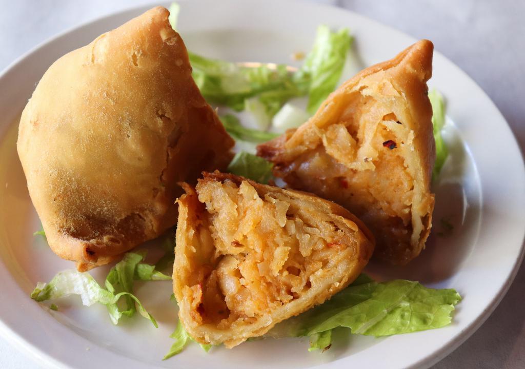 Vegetable Samosa (2 Pieces) · Lightly spiced Indian turnovers, stuffed potatoes and peas.