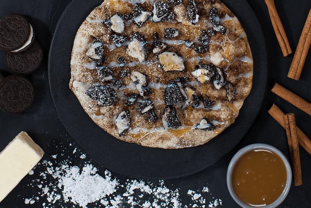 Dessert Pizza · homemade dough, melted butter, cinnamon, oreo crumbles, caramel and icing drizzle, powdered sugar