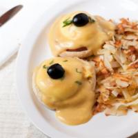 Eggs Benedict · (Two) eggs poached and ham served on a English muffin smothered in hollandaise sauce with ha...