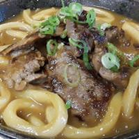Beef Curry Udon  · Japanese style curry with beef and assorted vegetables, served with udon noodles in our deli...