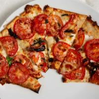 Roasted Tomato & Goat Cheese Flatbread · Sun Dried Tomatoes, Garlic, Pine nuts, Mozzarella and Parmesan Cheese, Basil