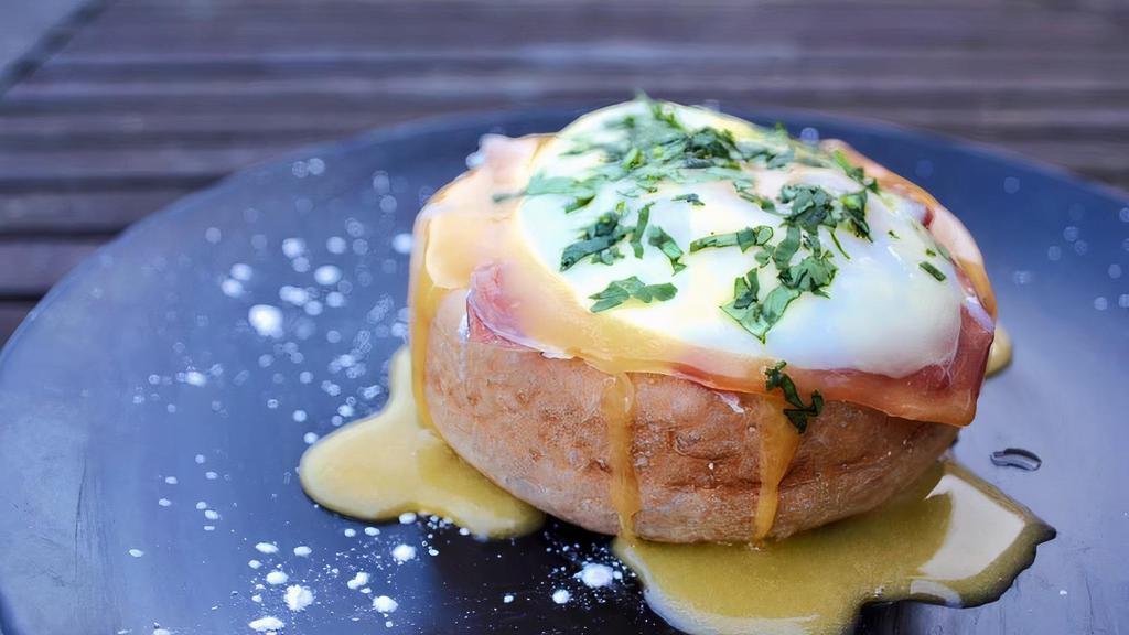 Eggs Benedict · Served with poached eggs on the top of brioche and hollandaise sauce, potatoes and salad.