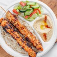 Chicken Kabab (Tawouk) Plate · Grilled marinated chicken breast served over rice, with hummus, garden salad and garlic spre...