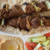 Beef Kabab Plate · Grilled marinated beef cubes served over rice, with hummus and garden salad.