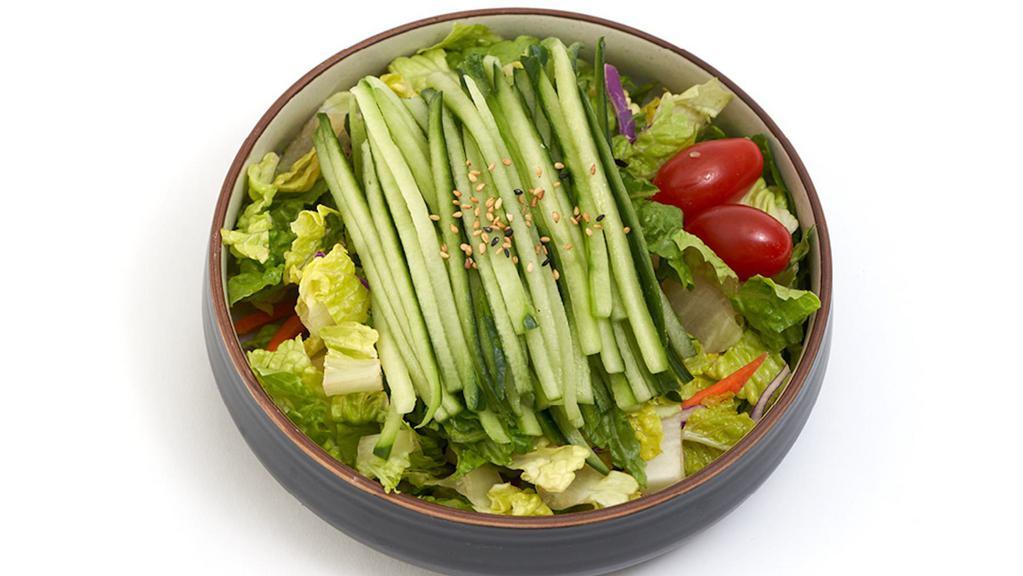Cucumber Salad · Large garden salad topped with a generous portion of cucumber.