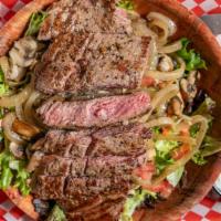 New York Steak Salad · mixed greens topped with diced tomato, sauteed mushrooms and onions, and a 8oz New yourk Ste...
