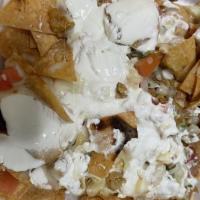 Super Nachos · Served with meat, cheese, beans, guacamole, cilantro, onions and sour cream.