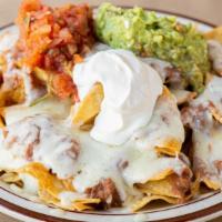 Nachos Deluxe · Layers of chips smothered with beans and cheese, salsa, guacamole and sour cream.
