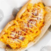 Mac Attack · Bacon wrapped Hot Dog topped with Mac n cheese, parmesan cheese and bacon bits.