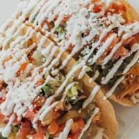 Tacos Americanos · Crispy tortillas, braised chicken, jack and cotija cheese, artisan romaine, salsa serrano, c...