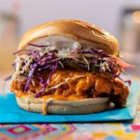 Buffalo Chicken Sandwich · country fried chicken breast tossed in buffalo sauce, slaw, lemon-herb mayo, pickles, brioch...