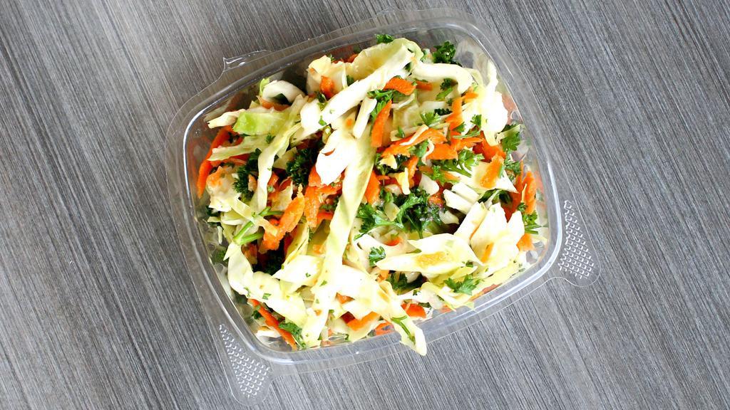 White Cabbage Salad · Sliced white cabbage, carrots, parsley, lemon juice and house spices.